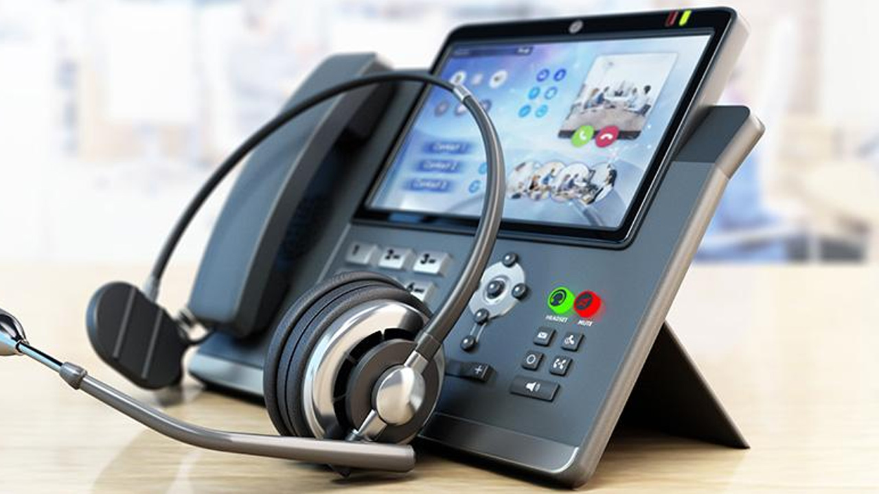 Video desk phone and headset ready for a support call